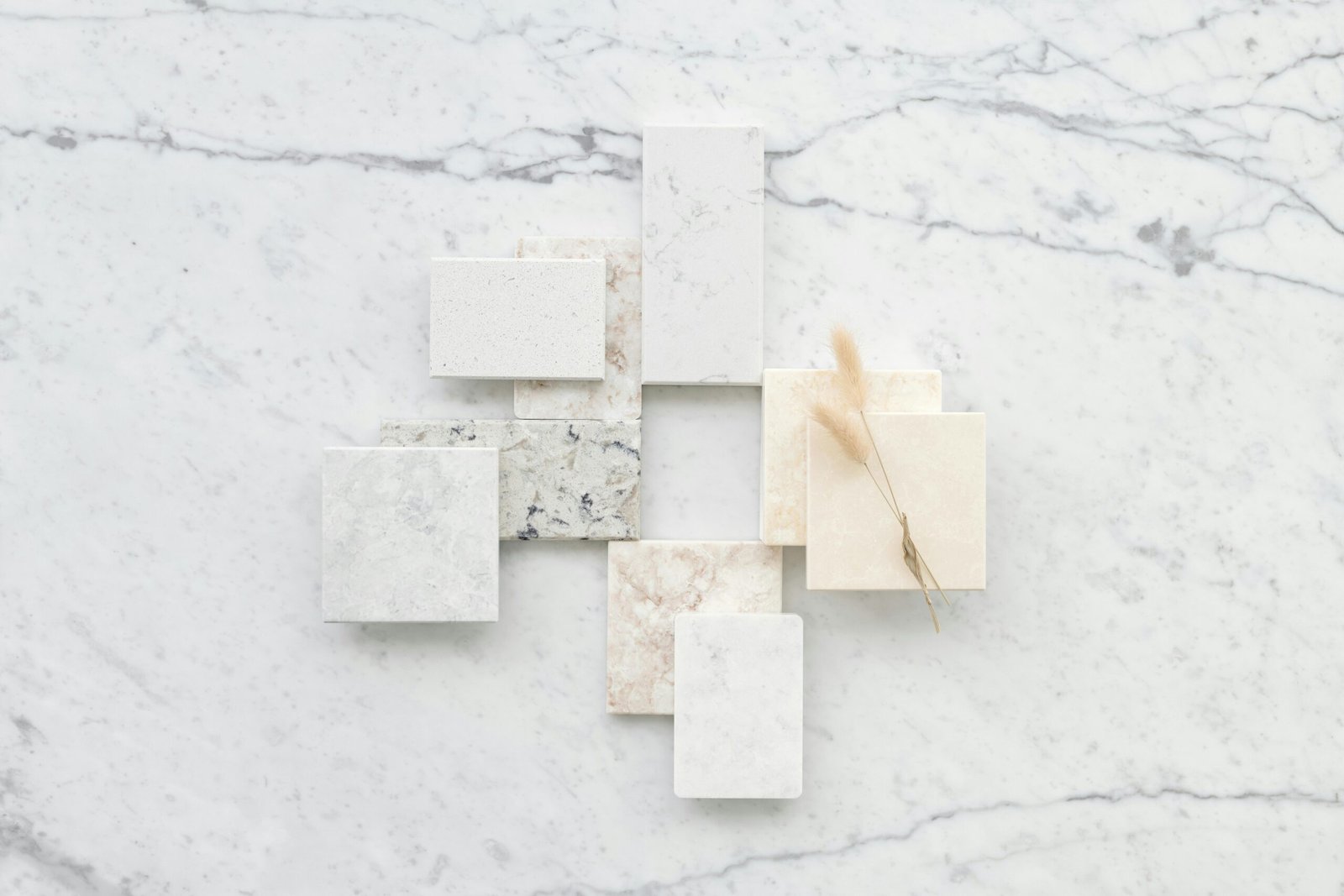 Stylish flat lay of marble tiles on a textured marble surface, ideal for design inspiration.